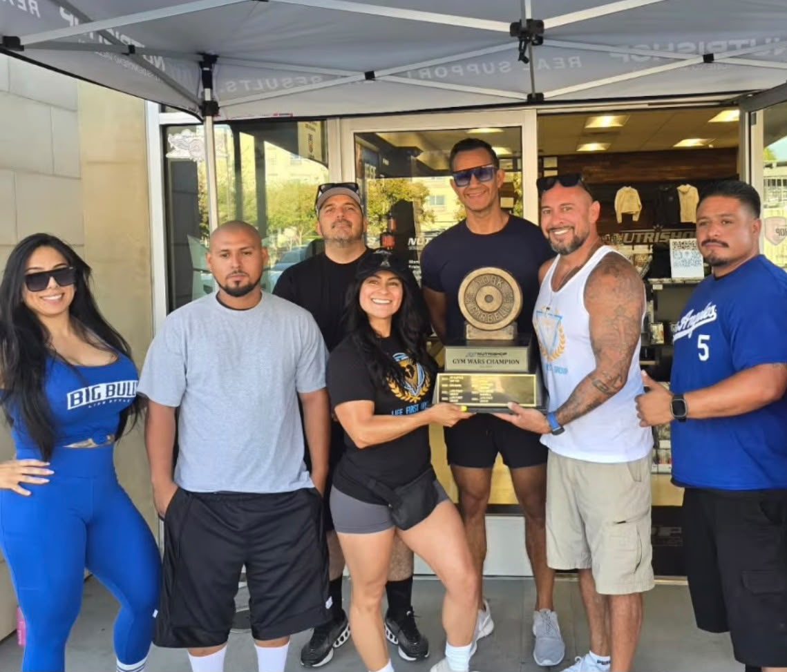 Evolve by L1G team celebrating with a Nutrishop Gym Wars trophy